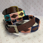 Leather belts with colourful stitch detail on a grey background