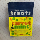 A bag of D&H Horse Treats carrot and mint dog treats, featuring a navy blue top half and a bright yellow bottom half with illustrations of carrots and mint leaves, set against a patterned backdrop of small sheep.