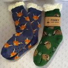 Two novelty socksdisplayed side-by-side on patterned paper. One sock is navy blue with orange cows, the other has horses prints and white sherpa trim.