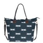 A Navy shopping bag by Sophie Allport with an all over dragonfly print in white and blue. The bag has a navy carry handle and a long over the bag strap with brass attachments.