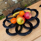 Fruit bowl made with black horseshoes with fruit in it