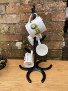 mug tree made with black horseshoes and mugs hanging on it