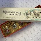Vintage 'Hunting Scenes' set of six decorated drinking glasses in their original illustrated box, photographed on patterned paper.