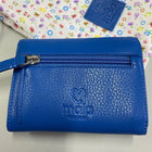 Bright blue leather purse, shown from the back with a zip coin pocket.