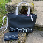 Navy Leather Horse Handbag with black, white and grey horses stitched on the front. Matching tri fold purse shown next to the bag.